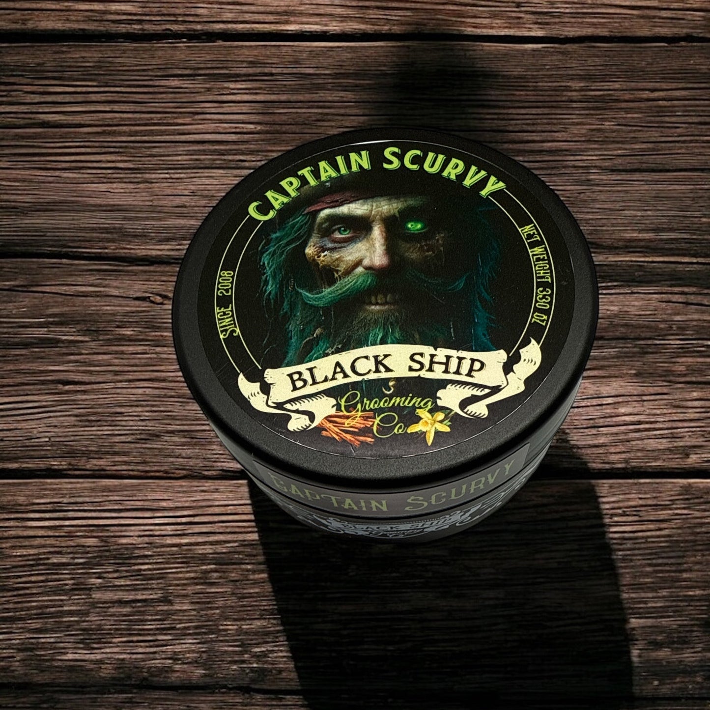 Container of Captain Scurvy shaving cream by Black Ship Grooming Co. on a wooden surface