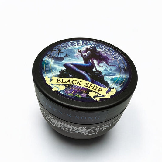 Black ship-themed Sirens's song shaving soap with a mermaid illustration on a white background